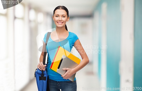 Image of smiling student with bag, folders and tablet pc