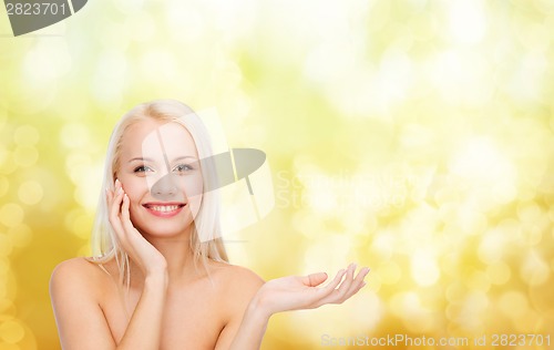 Image of smiling woman holding imaginary lotion jar