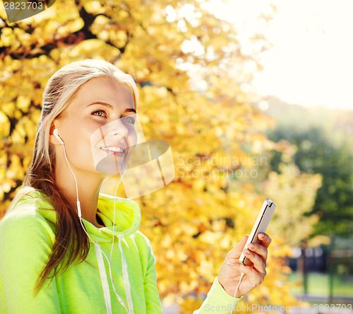 Image of woman listening to music outdoors