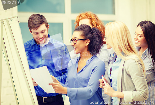 Image of smiling business team having discussion in office