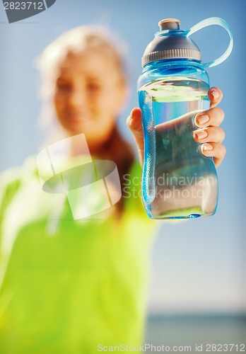 Image of woman showing a bottle of water