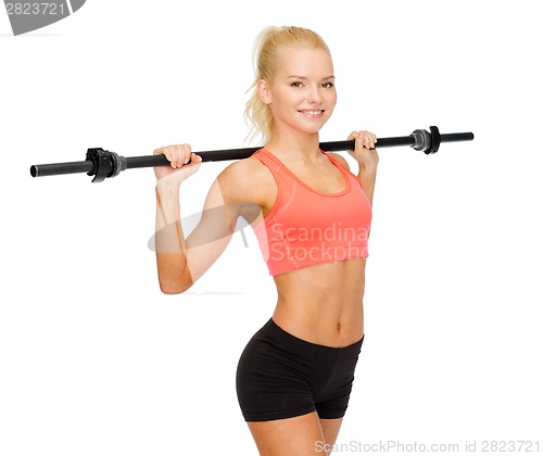 Image of smiling sporty woman exercising with barbell