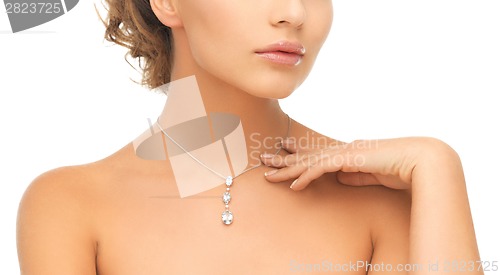 Image of woman wearing shiny diamond pendant