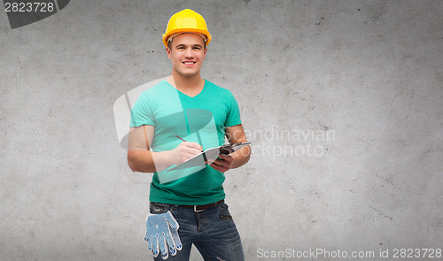 Image of smiling man in helmet with clipboard