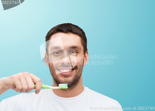 Image of smiling young man with toothbrush