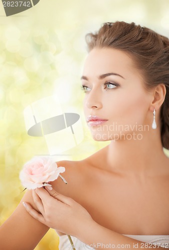 Image of young woman with rose flower