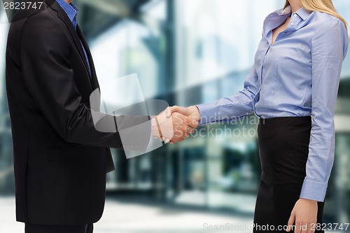 Image of businessman and businesswoman shaking hands