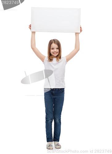 Image of smiling little child holding blank white board