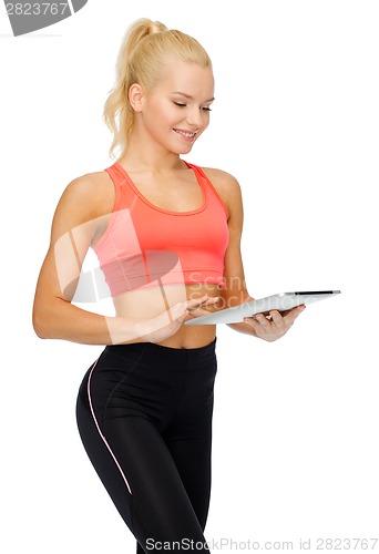 Image of smiling sporty woman with tablet pc computer