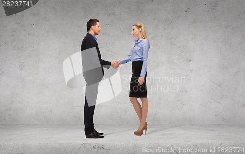 Image of businessman and businesswoman shaking hands