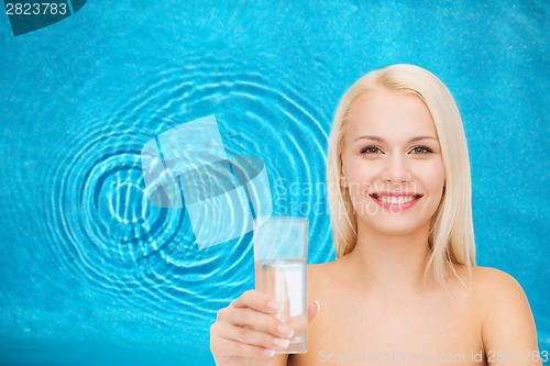 Image of young smiling woman with glass of water