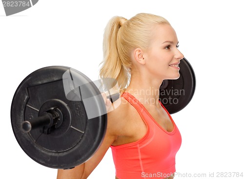 Image of smiling sporty woman exercising with barbell