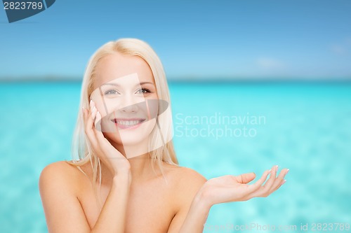 Image of smiling woman holding imaginary lotion jar