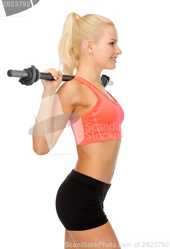 Image of smiling sporty woman exercising with barbell