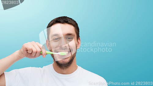 Image of smiling young man with toothbrush