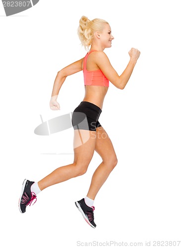 Image of sporty woman running or jumping