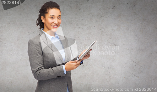 Image of smiling woman looking at tablet pc