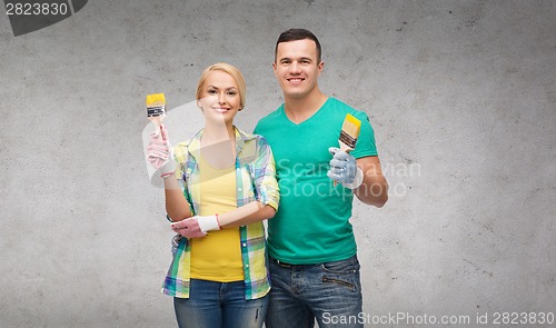 Image of smiling couple with paintbrush