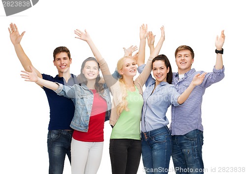 Image of group of smiling students waving hands