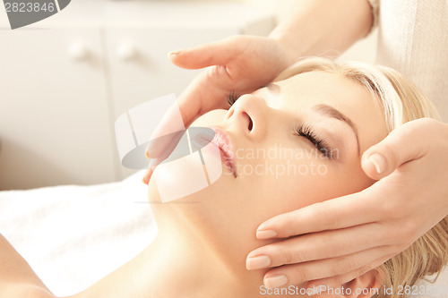 Image of beautiful woman in massage salon