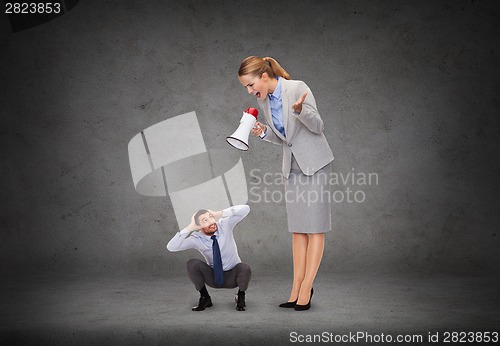 Image of angry businesswoman with megaphone