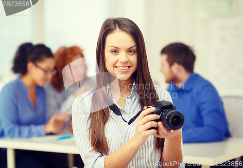 Image of smiling female photographer with photocamera