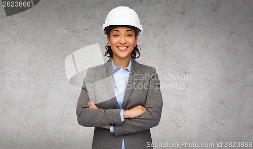 Image of businesswoman in white helmet with crossed arms
