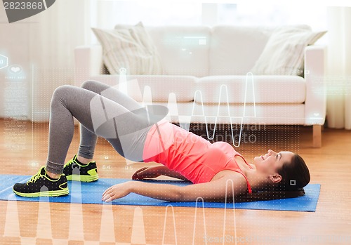 Image of smiling girl doing exercise for legs and buttocks