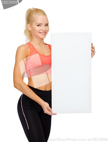 Image of smiling sportswoman with white blank board