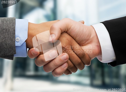 Image of businessman and businesswoman shaking hands