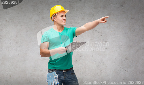 Image of smiling man in helmet with clipboard