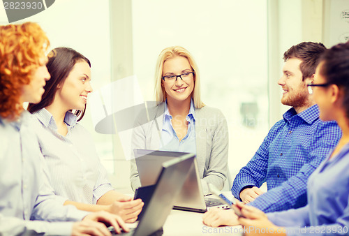 Image of smiling team with laptop and table pc computers