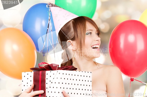 Image of party girl with balloons and gift box
