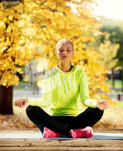 Image of woman doing yoga outdoors