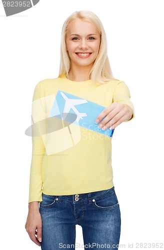 Image of smiling young woman with airplane ticket