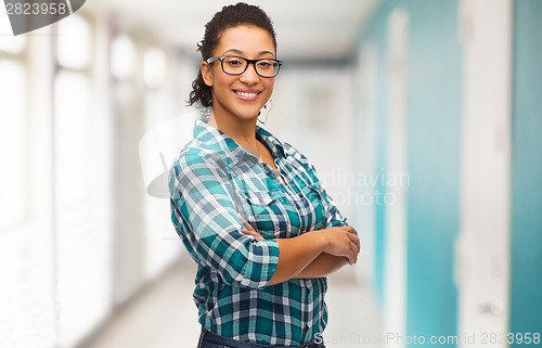 Image of smiling young woman in eyeglasses at school