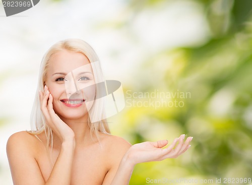 Image of smiling woman holding imaginary lotion jar