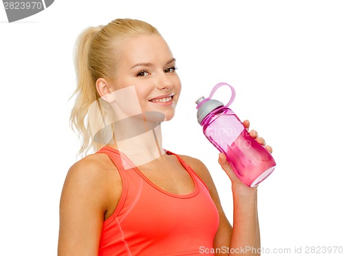 Image of smiling sporty woman with water bottle