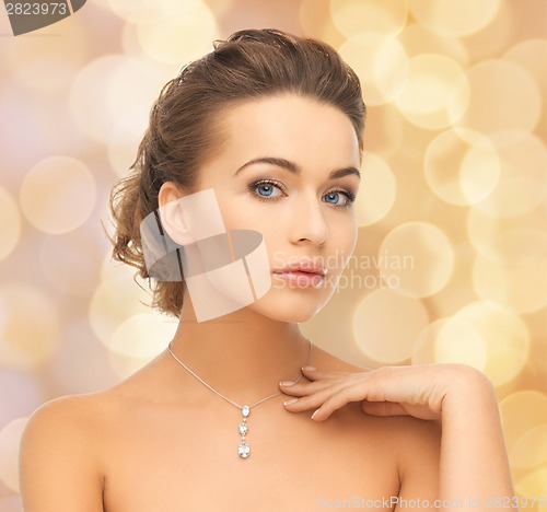 Image of woman wearing shiny diamond pendant