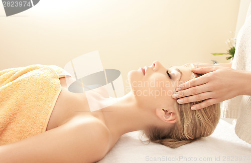 Image of beautiful woman in massage salon