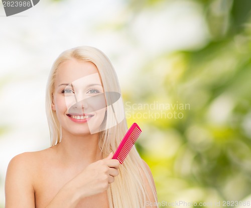 Image of smiling woman with hair brush