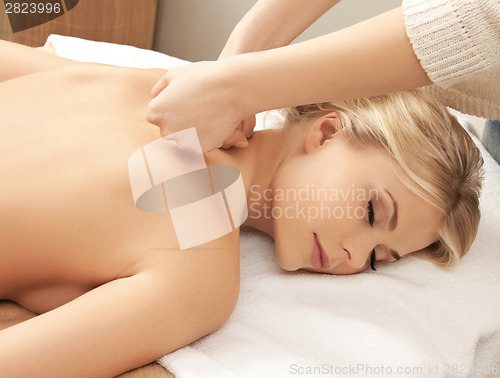 Image of beautiful woman in massage salon