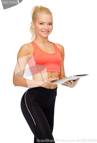 Image of smiling sporty woman with tablet pc computer