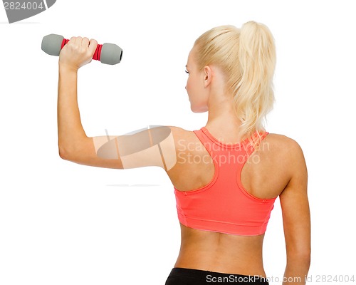 Image of young sporty woman with light dumbbell