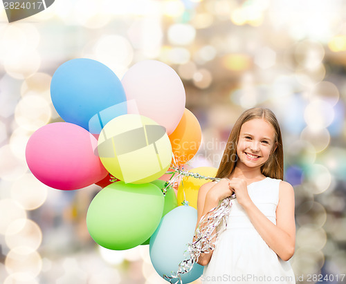 Image of happy girl with colorful balloons