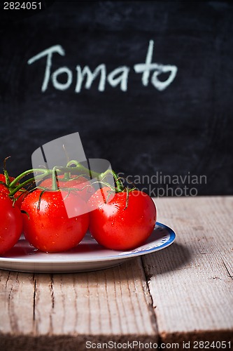 Image of fresh tomatoes and blackboard 