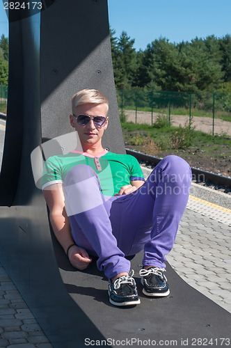 Image of Handsome man sitting on the seat