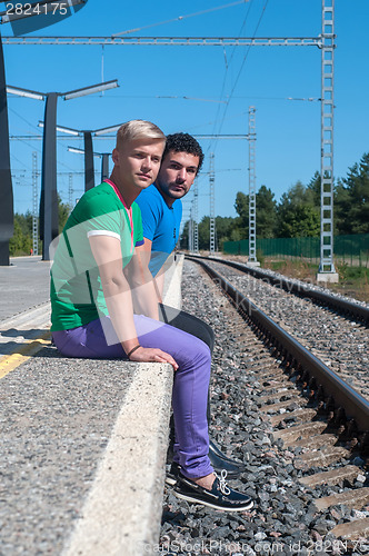 Image of Two young men sitting on the platform