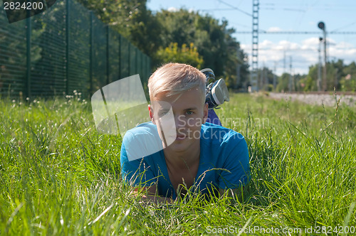 Image of Handsome young guy on the grass