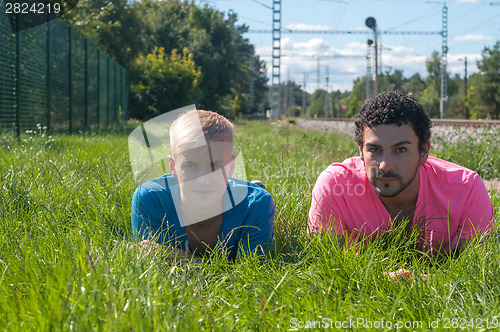 Image of Two handsome young guys on the grass